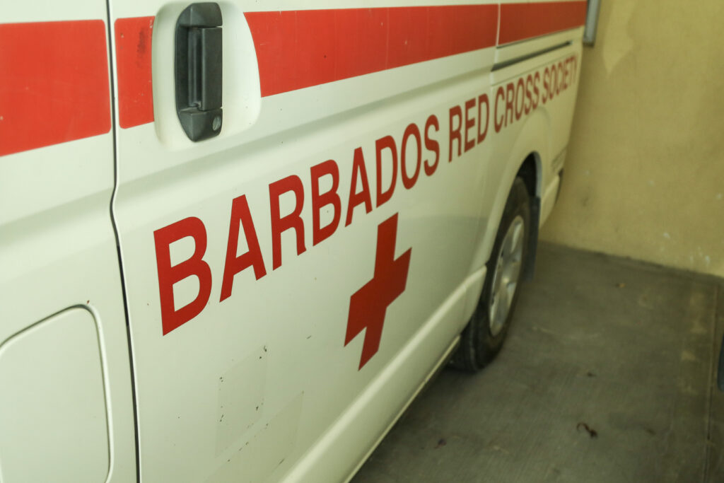 Close up image of the side of the Barbados Red Cross ambulance, taken at a slight angle.