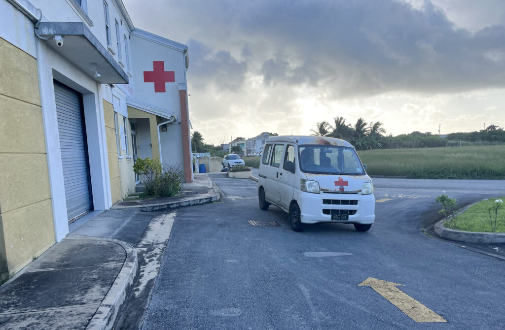 Image of an ambulance with the Barbados Red Cross Society building in the background.